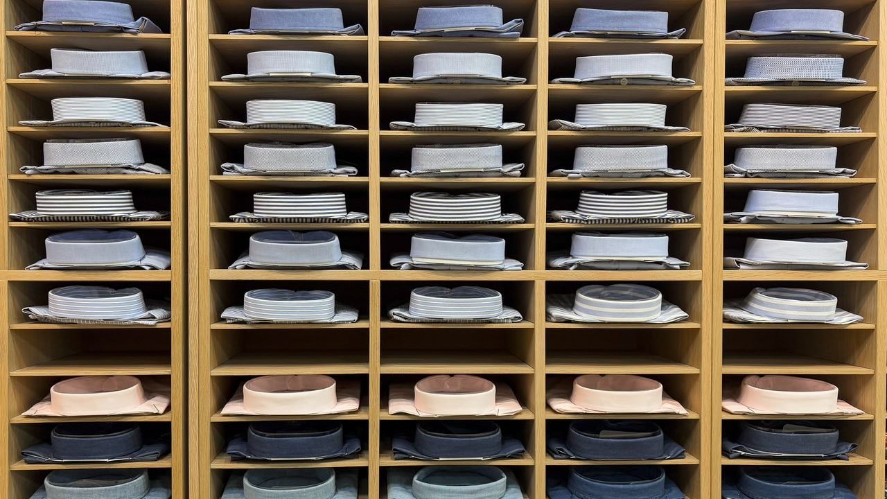 Folded shirts arranged in wooden cubbies