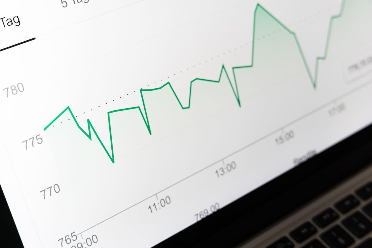 Green line chart on a laptop screen