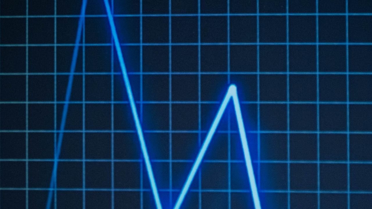 Glowing blue line graph on a dark grid