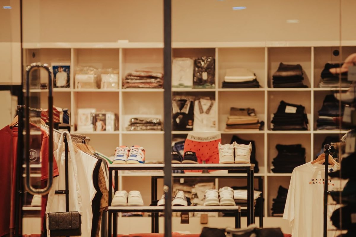 Clothes and accessories arranged on shelves and racks in a boutique