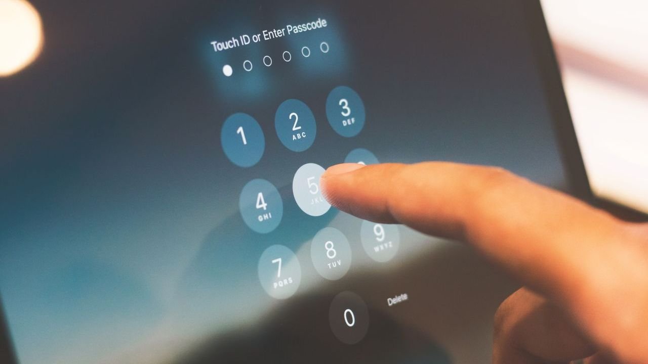 Finger tapping a passcode screen on a tablet