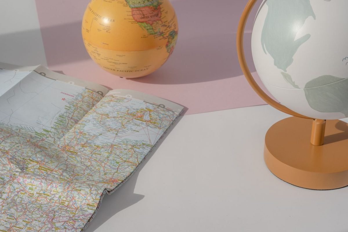 Open road map and two globes on a table