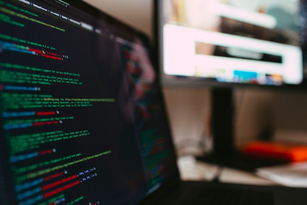 Green and white source code on a dark monitor