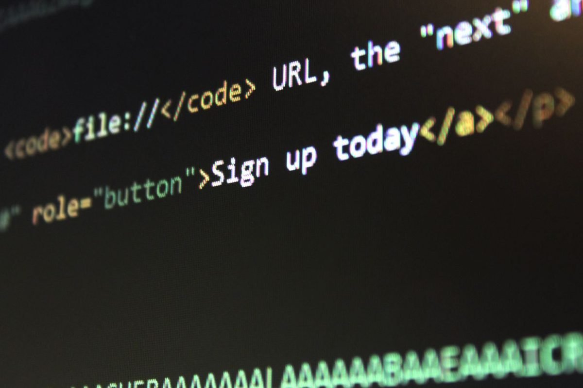 HTML markup with a link and a button shown on a dark code screen