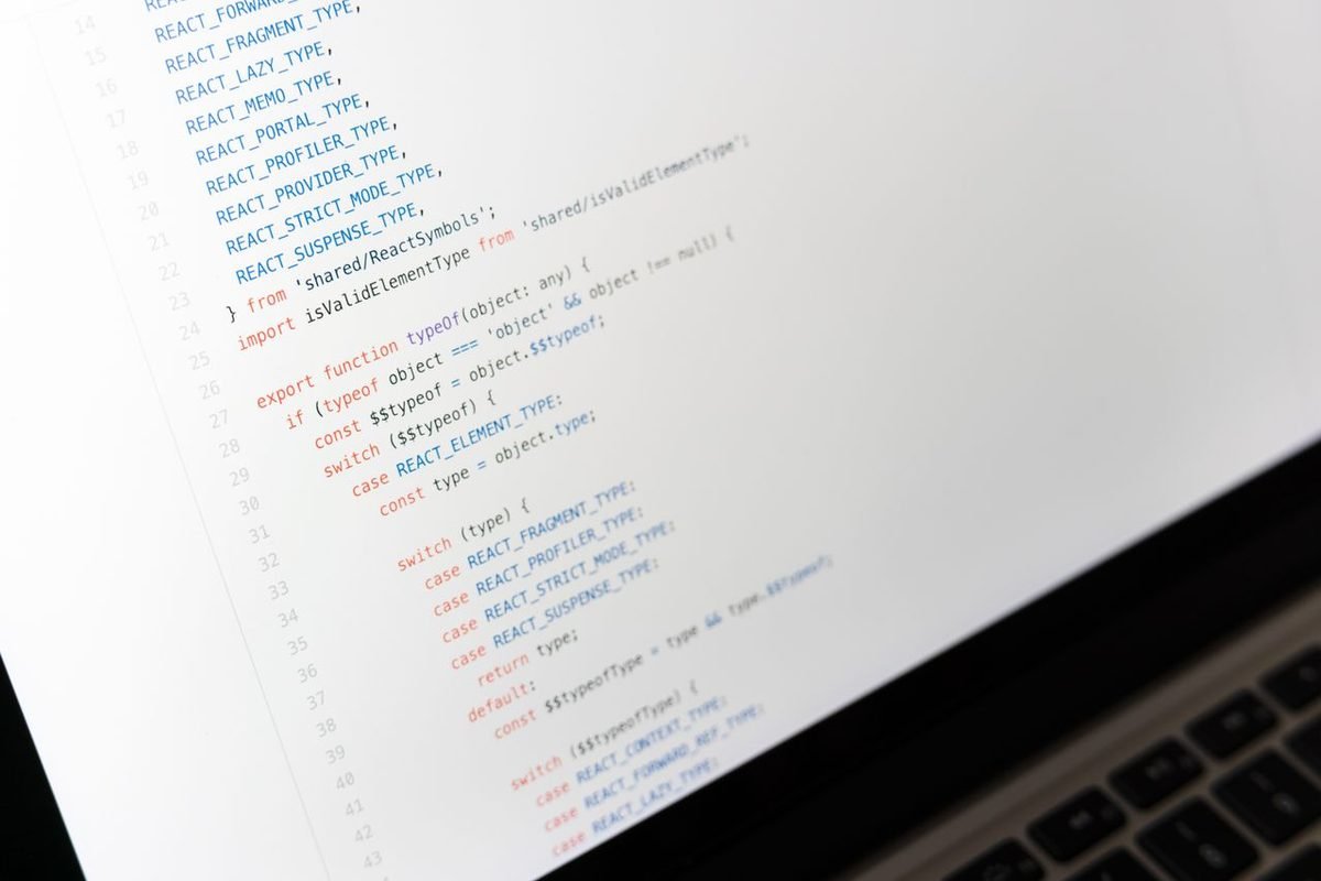 Source code on a laptop screen with a white background