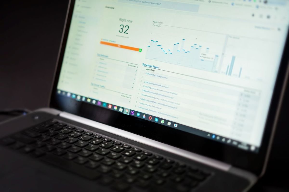 Laptop screen showing a dashboard with metrics and a graph