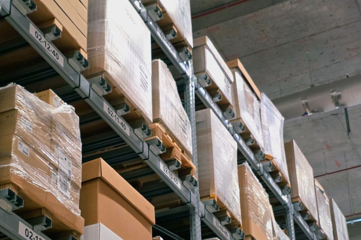 Rows of boxes on tall warehouse shelves