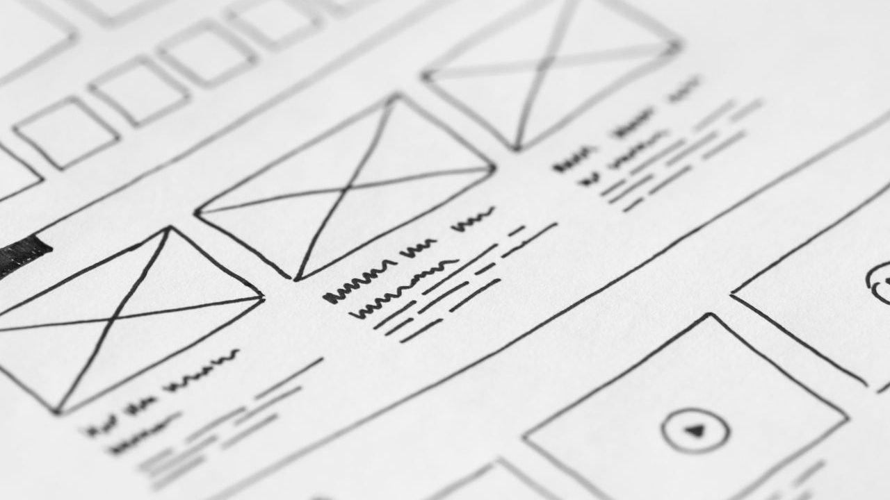 Hand-drawn website wireframe sketched on paper