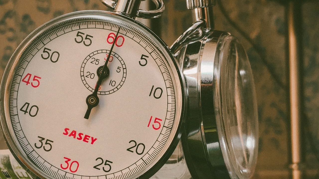 Analog stopwatch on a reflective surface