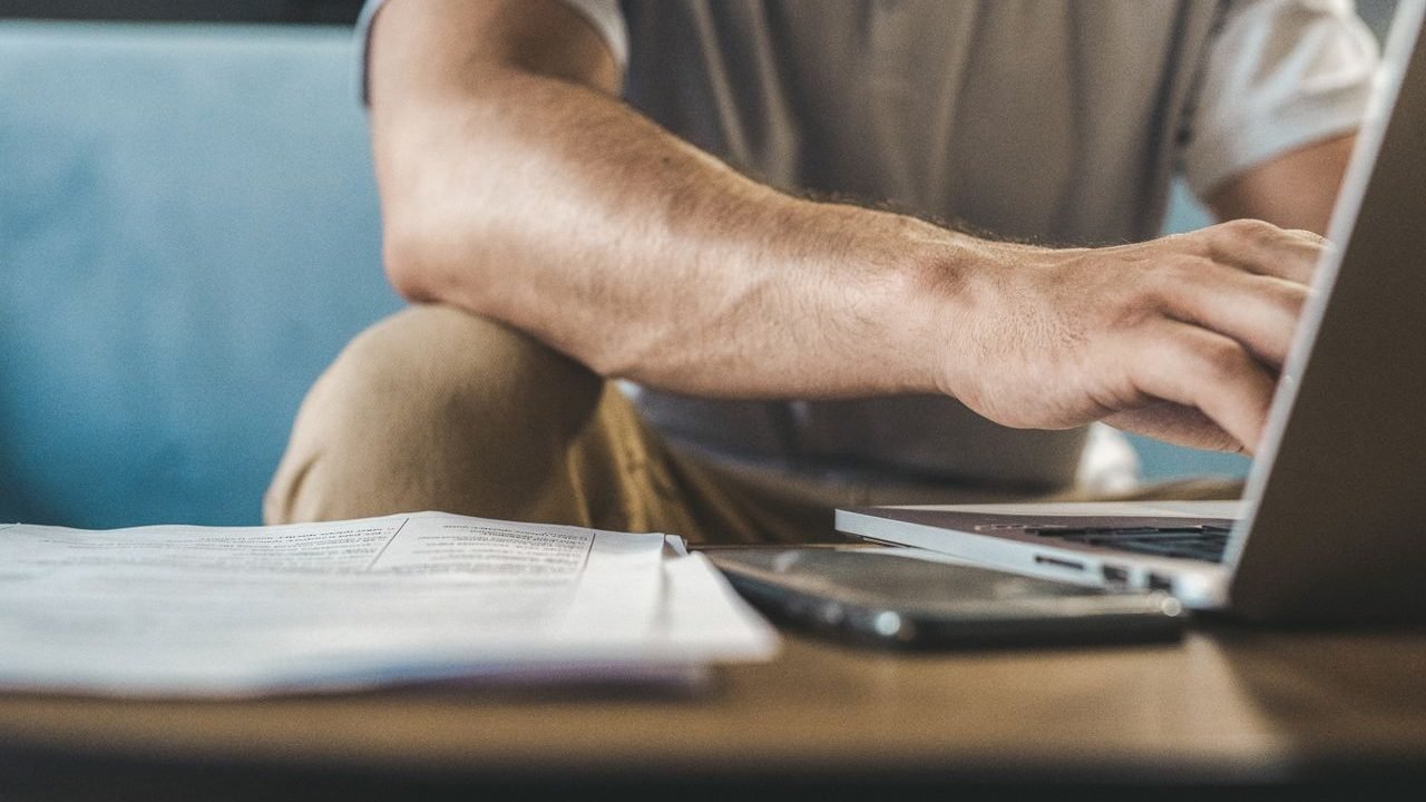 Person typing on a laptop at a desk
