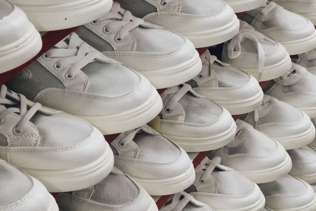 Stacks of white sneakers in a store display